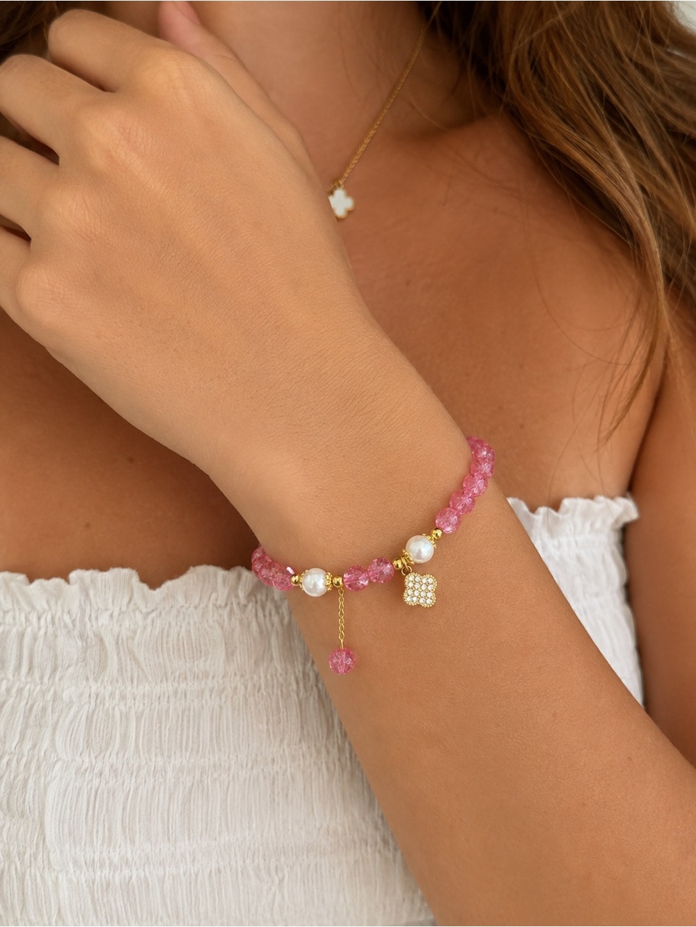 Hot pink beaded bracelet with clover charm